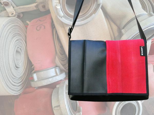 Upcycling Bags made from a used red fire hose and tarpaulin